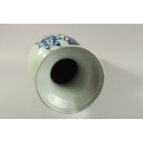 42 - A LARGE CHINESE PALE CELADON BLUE AND WHITE PORCELAIN VASE, painted with a spray of flora, the neck ... 