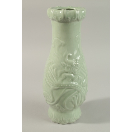 50 - A CHINESE CELADON GLAZE PORCELAIN VASE, with carved dragon and ruyi decoration, the base with charac... 