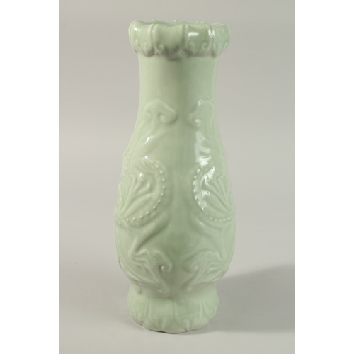 50 - A CHINESE CELADON GLAZE PORCELAIN VASE, with carved dragon and ruyi decoration, the base with charac... 