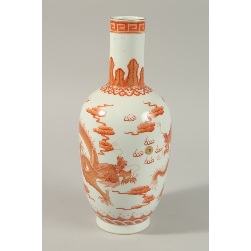 51 - A CHINESE COPPER RED AND WHITE PORCELAIN DRAGON VASE, painted with two dragons and the flaming pearl... 