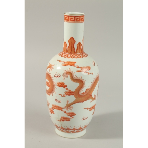 51 - A CHINESE COPPER RED AND WHITE PORCELAIN DRAGON VASE, painted with two dragons and the flaming pearl... 