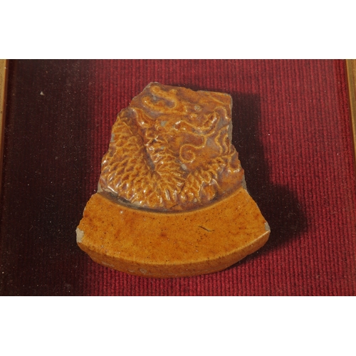 55 - AN 18TH-19TH CENTURY CHINESE GLAZED POTTERY TILE FRAGMENT, depicting a dragon, inset within glazed d... 