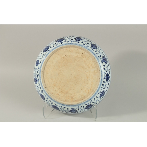 59 - A CHINESE BLUE AND WHITE PORCELAIN CHARGER, painted with flower heads, 33.5cm diameter.