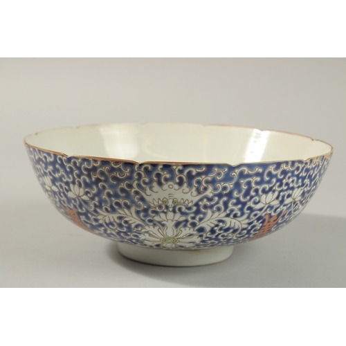 60 - AN EARLY 20TH CENTURY CHINESE BLUE GROUND PORCELAIN BOWL, with enamel-painted bats and floral motifs... 