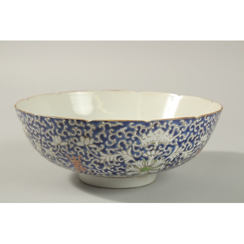 60 - AN EARLY 20TH CENTURY CHINESE BLUE GROUND PORCELAIN BOWL, with enamel-painted bats and floral motifs... 