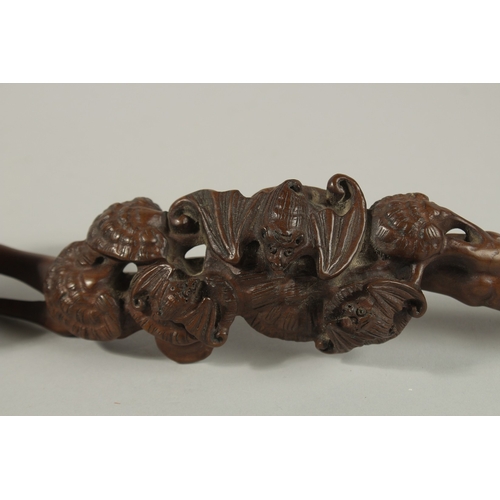 A CHINESE CARVED WOOD RUYI SCEPTRE, with naturalistic carving of ...