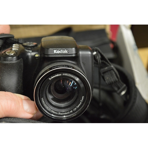 132 - A box of assorted cameras and equipment etc.