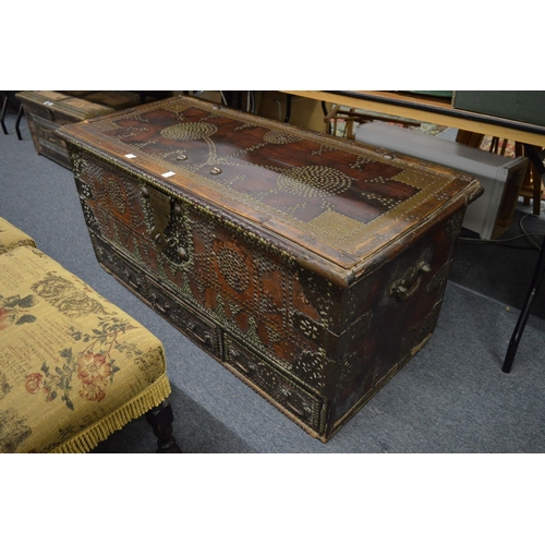 311 - A good Eastern brass bound hardwood trunk with brass studded decoration and three drawers to the bas... 