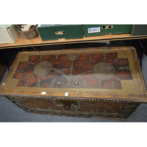 311 - A good Eastern brass bound hardwood trunk with brass studded decoration and three drawers to the bas... 