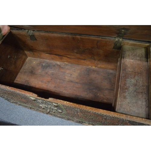 311 - A good Eastern brass bound hardwood trunk with brass studded decoration and three drawers to the bas... 