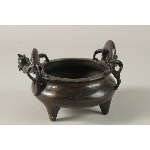 14 - A CHINESE BRONZE TRIPOD CENSER, with twin dragon-form handles, the base with character mark, 17.5cm ... 