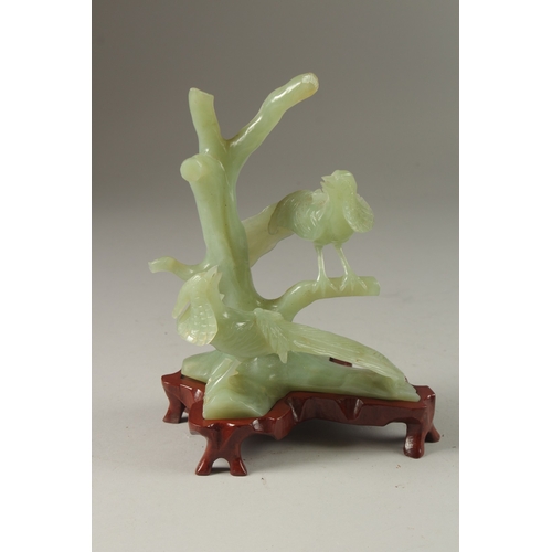 3 - A CHINESE CARVED JADE GROUP ON HARDWOOD STAND, the group carved with pea hens on tree branches, jade... 