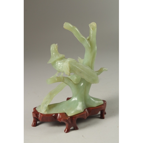 3 - A CHINESE CARVED JADE GROUP ON HARDWOOD STAND, the group carved with pea hens on tree branches, jade... 