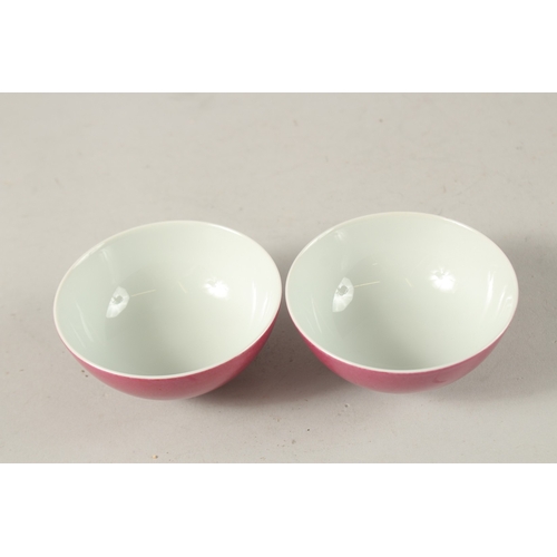 35 - A PAIR OF CHINESE PINK GLAZE PORCELAIN TEACUPS, with character mark to base, 8.5cm diameter.