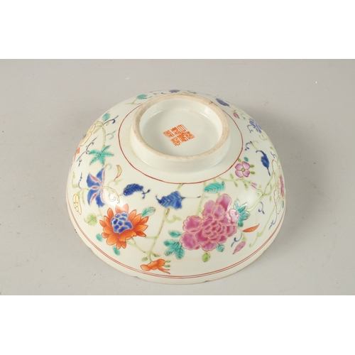 39 - A CHINESE POLYCHROME PORCELAIN BOWL, enamel painted with native flora, 23cm diameter.