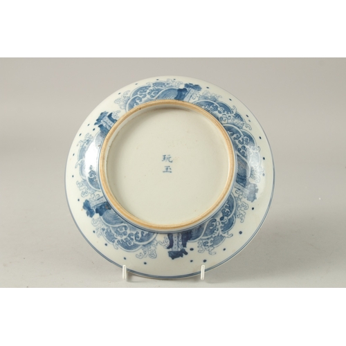 40 - A CHINESE BLUE AND WHITE PORCELAIN PLATE, painted with female figures, the base with character mark,... 