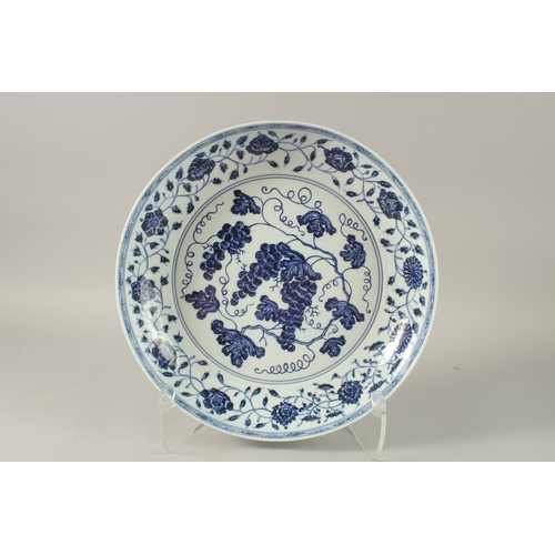 42 - A CHINESE BLUE AND WHITE PORCELAIN CHARGER, painted with a central panel of grapes and border of lot... 