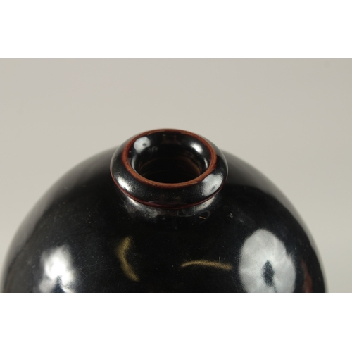 43 - A CHINESE BLACK GROUND CIZHOU VASE, 32cm high.