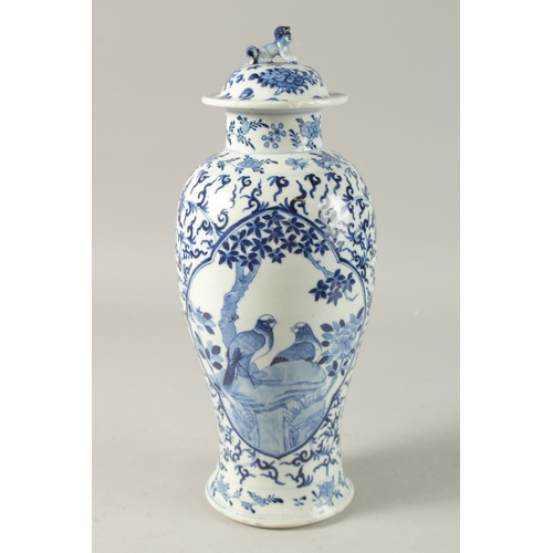 47 - A CHINESE BLUE AND WHITE PORCELAIN LIDDED VASE, finely painted with two mirrored panels of of birds ... 