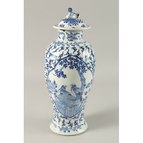 47 - A CHINESE BLUE AND WHITE PORCELAIN LIDDED VASE, finely painted with two mirrored panels of of birds ... 