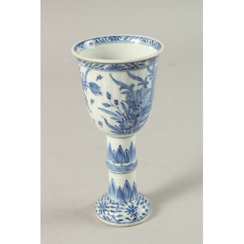 50 - A CHINESE KANGXI PERIOD BLUE AND WHITE PORCELAIN STEM CUP, finely painted with native flora, 15.5cm ... 