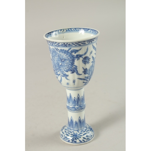 50 - A CHINESE KANGXI PERIOD BLUE AND WHITE PORCELAIN STEM CUP, finely painted with native flora, 15.5cm ... 