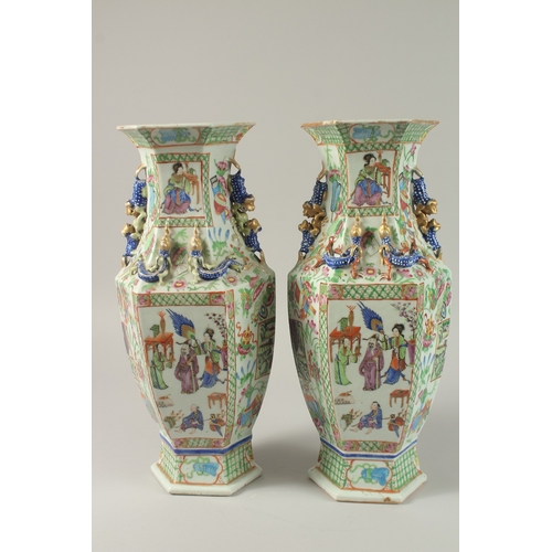 52 - A PAIR OF CHINESE CANTON FAMILLE ROSE PORCELAIN HEXAGONAL VASES, painted with panels of figures and ... 