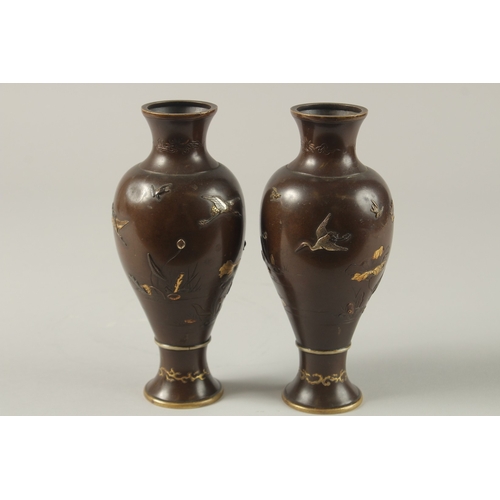 61 - A FINE PAIR OF JAPANESE MEIJI PERIOD MIXED METAL INLAID BRONZE VASES, decorated with gilt and silver... 