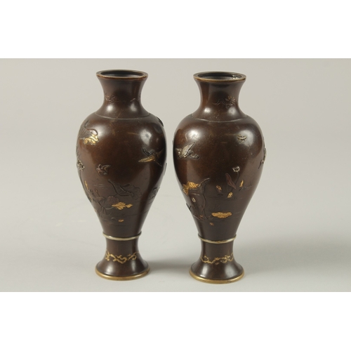 61 - A FINE PAIR OF JAPANESE MEIJI PERIOD MIXED METAL INLAID BRONZE VASES, decorated with gilt and silver... 