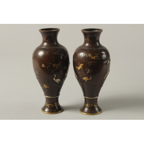 61 - A FINE PAIR OF JAPANESE MEIJI PERIOD MIXED METAL INLAID BRONZE VASES, decorated with gilt and silver... 