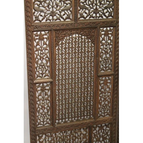 99 - A FINE INDIAN CARVED SANDALWOOD OPENWORKED FOUR PANEL SCREEN, with carved birds and foliate designs,... 