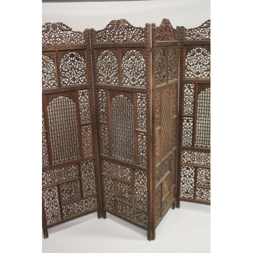 99 - A FINE INDIAN CARVED SANDALWOOD OPENWORKED FOUR PANEL SCREEN, with carved birds and foliate designs,... 