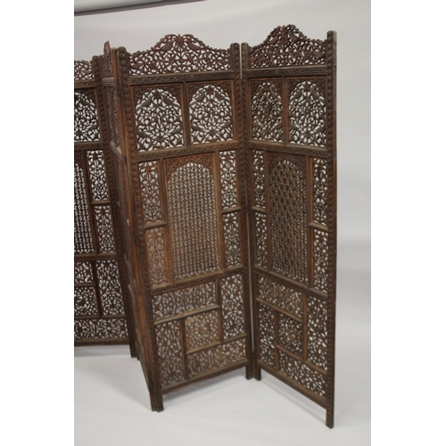 99 - A FINE INDIAN CARVED SANDALWOOD OPENWORKED FOUR PANEL SCREEN, with carved birds and foliate designs,... 