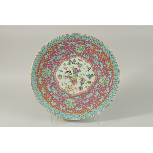 58 - A FINE CHINESE FAMILLE ROSE PORCELAIN CHARGER, painted with central panel depicting precious objects... 