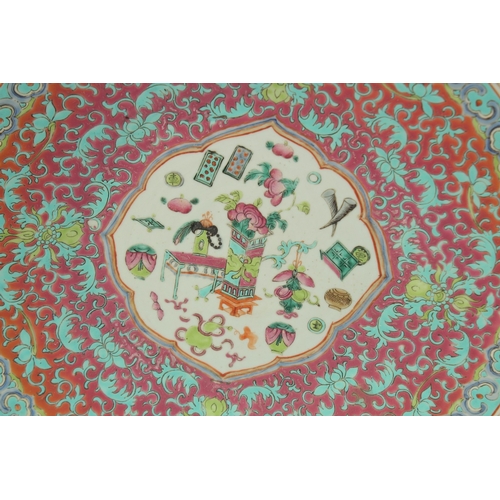 58 - A FINE CHINESE FAMILLE ROSE PORCELAIN CHARGER, painted with central panel depicting precious objects... 