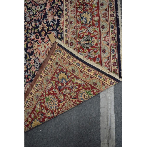 1011 - A GOOD LARGE KIRMAN, 396cm x 300cm.