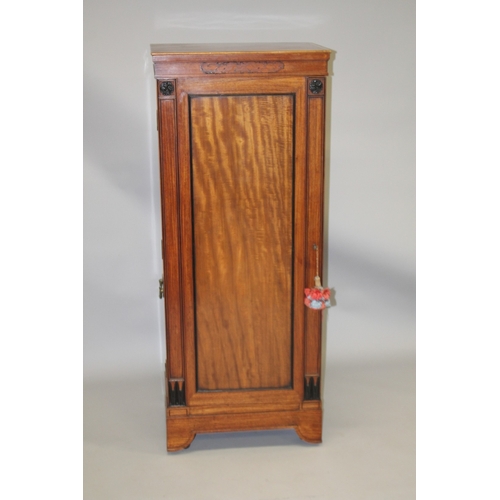 1027 - AN UNSUAL 19TH CENTURY CAMPHOR WOOD AND EBONY CABINET, probably Colonial, the full length hinged pan... 