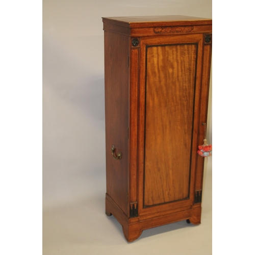 1027 - AN UNSUAL 19TH CENTURY CAMPHOR WOOD AND EBONY CABINET, probably Colonial, the full length hinged pan... 