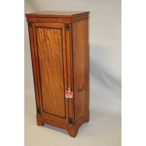 1027 - AN UNSUAL 19TH CENTURY CAMPHOR WOOD AND EBONY CABINET, probably Colonial, the full length hinged pan... 