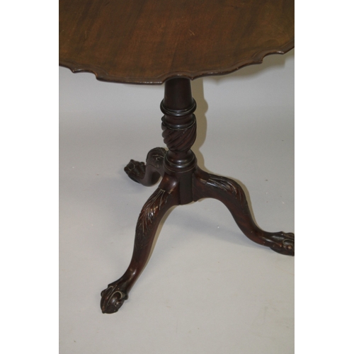 1029 - A GEORGE III MAHOGANY TILT TOP TRIPOD TABLE with pie crust top, carved and turned column support, on... 