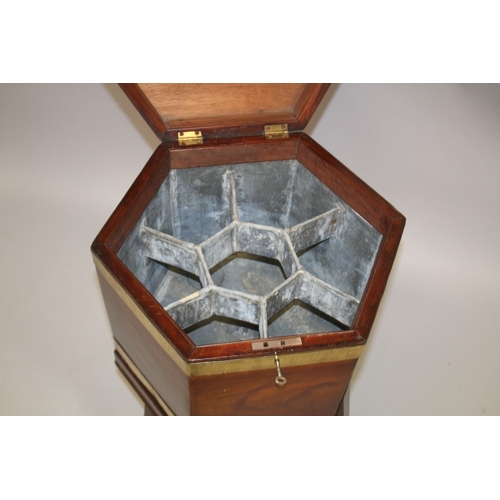 1030 - A GOOD GEORGE III MAHOGANY AND BRASS BOUND HEXAGONAL SHAPED CELLERETTE, the hinged top revealing a c... 