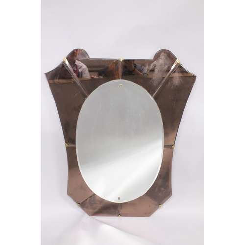 1042 - A 1950'S ITALIAN WALL MIRROR, with oval mirror plate within a shaped, coloured mirrored surround. 3f... 