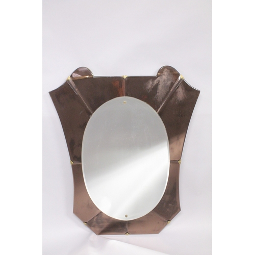 1042 - A 1950'S ITALIAN WALL MIRROR, with oval mirror plate within a shaped, coloured mirrored surround. 3f... 