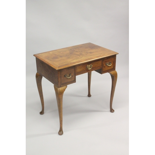 1043 - A GEORGE III DESIGN WALNUT LOW BOY, with a central drawer flanked by a pair of deep drawers on cabri... 