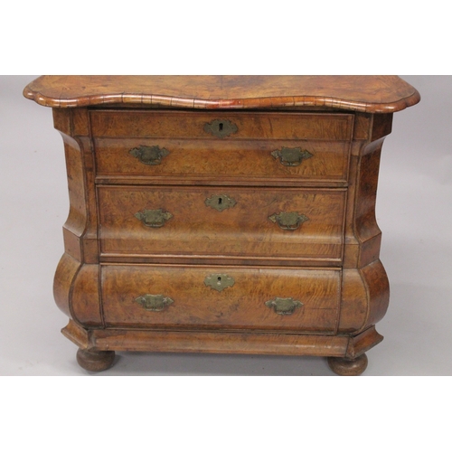 1063 - A GOOD 18TH CENTURY DUTCH WALNUT COMMODE, with crossbanded shaped top, three drawers with brass hand... 