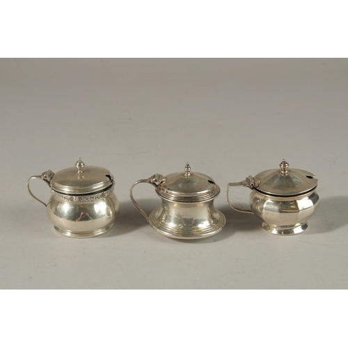 1806 - THREE VARIOUS SILVER CIRCULAR PLAIN MUSTARD POTS with sapphire blue liners. Birmingham 1930 and 1951... 