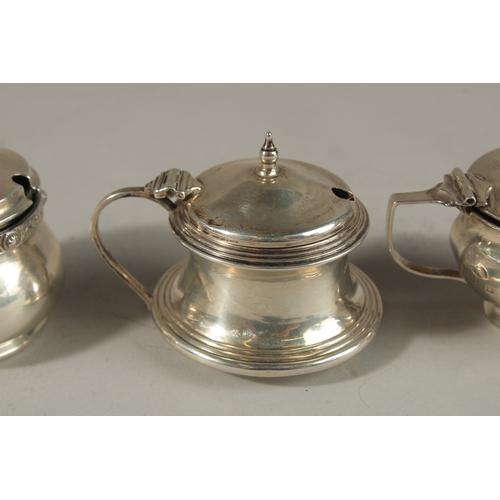 1806 - THREE VARIOUS SILVER CIRCULAR PLAIN MUSTARD POTS with sapphire blue liners. Birmingham 1930 and 1951... 