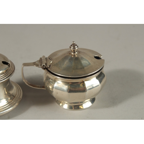 1806 - THREE VARIOUS SILVER CIRCULAR PLAIN MUSTARD POTS with sapphire blue liners. Birmingham 1930 and 1951... 