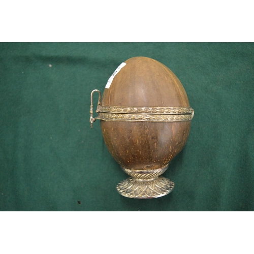 1045 - A white metal mounted coconut box with hinged cover.