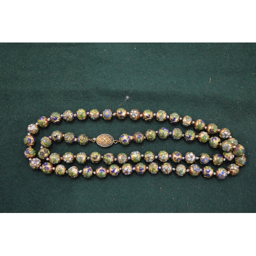 1100 - An enamel decorated bead necklace.